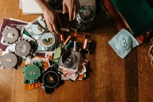 Hand embroidering a badge with needle and thread